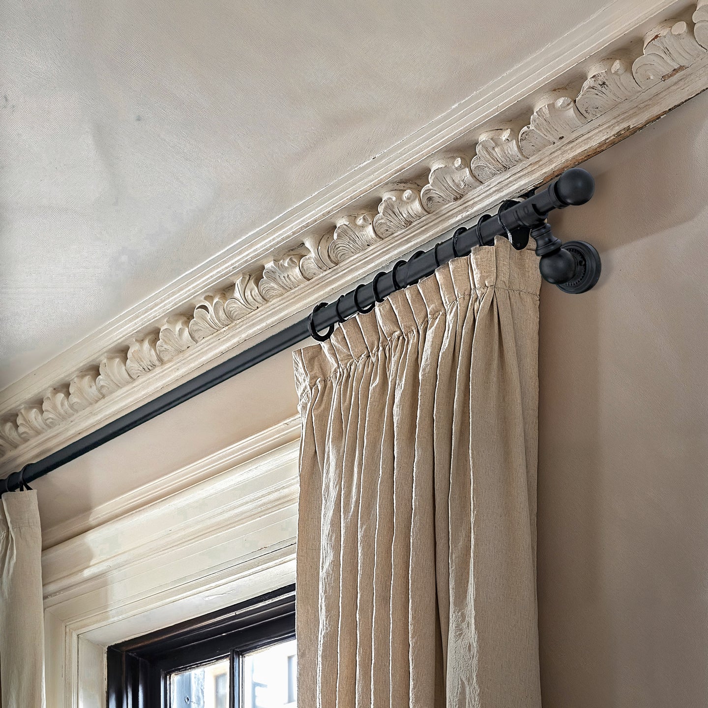 Black ornate metal curtain rail wrought iron wall mounted