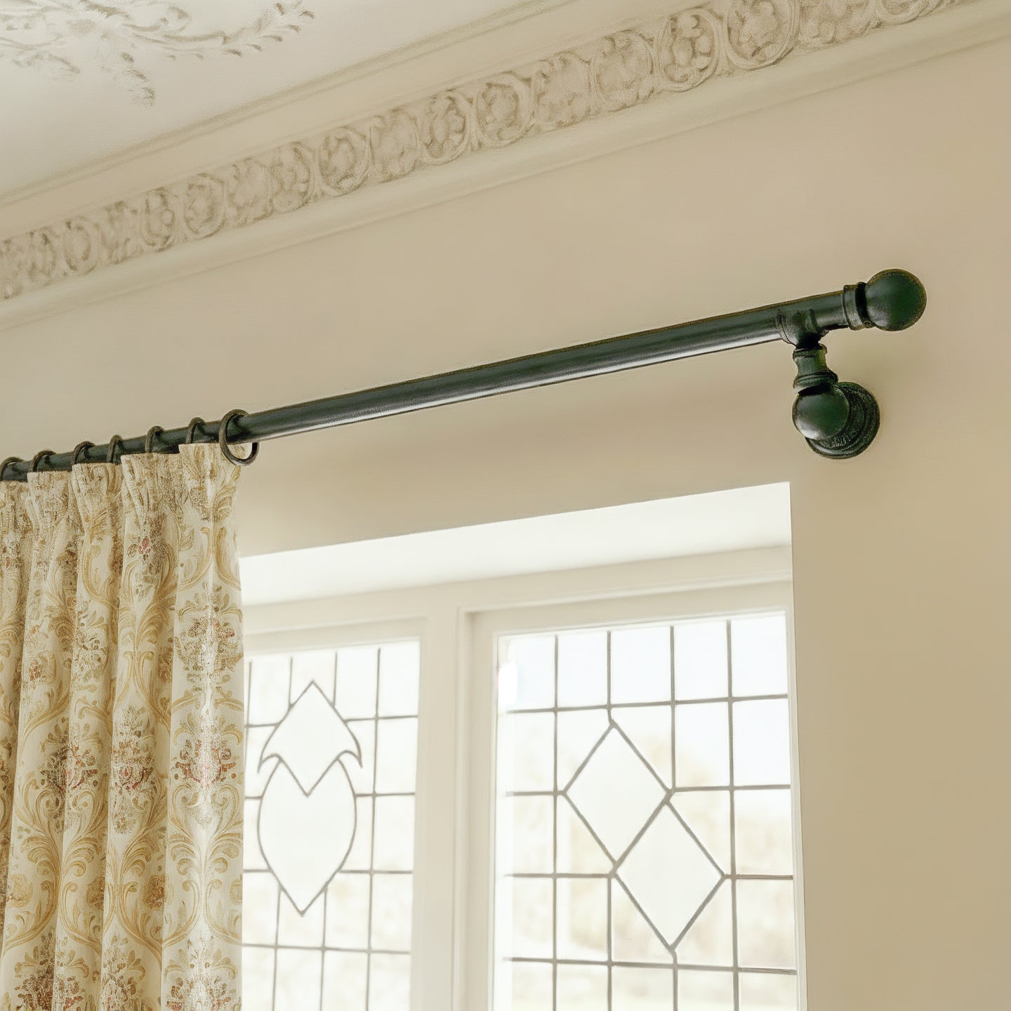 Black ornate metal curtain rail wrought iron wall mounted