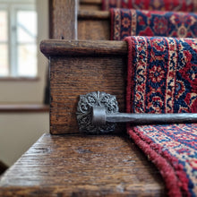 Load image into Gallery viewer, Ornate Square Stair Rods with Hammered Bar, across a carpet runner on wooden stairs
