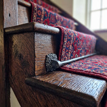 Load image into Gallery viewer, Ornate Square Stair Rods with Hammered Bar, across a carpet runner on wooden stairs
