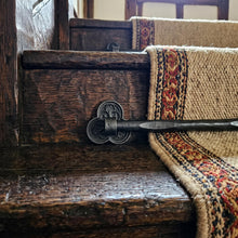 Load image into Gallery viewer, Tudor Trefoil Stair Rods with Hammered Bar, across a carpet runner on wooden stairs
